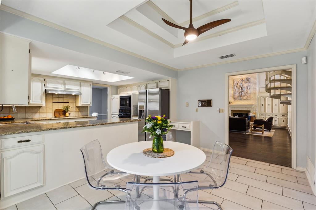 4130 High Star Lane Dallas, TX 75287 - Photo 18 of 38 a dining room with stainless steel appliances granite countertop a stove a kitchen island a dining table and chairs