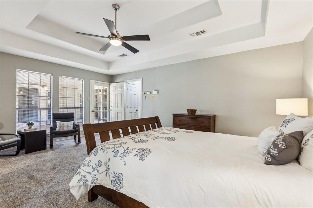 4130 High Star Lane Dallas, TX 75287 - Photo 22 of 38 a bedroom with a bed and a chandelier