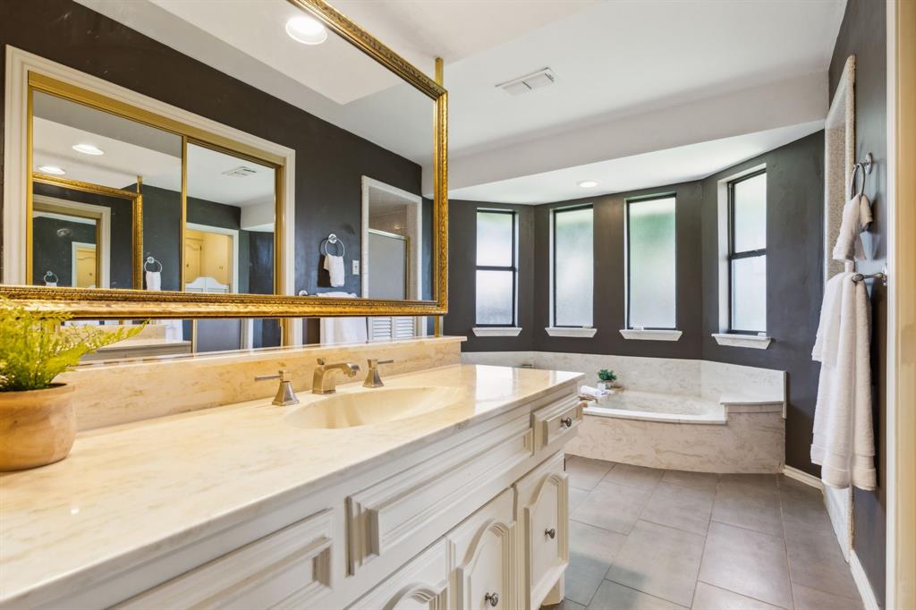 4130 High Star Lane Dallas, TX 75287 - Photo 23 of 38 a bathroom with a tub sink and mirror