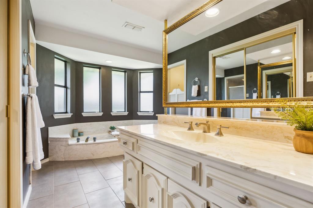 4130 High Star Lane Dallas, TX 75287 - Photo 24 of 38 a bathroom with a tub sink and mirror