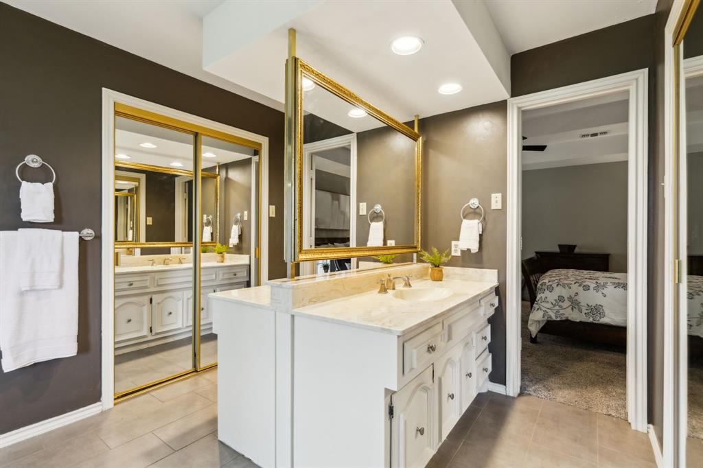 4130 High Star Lane Dallas, TX 75287 - Photo 25 of 38 a room with a bed and a large mirror