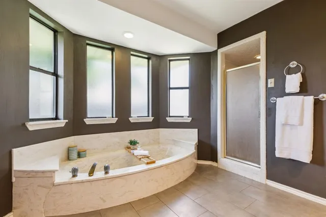 a bedroom with a bed and a ceiling fan