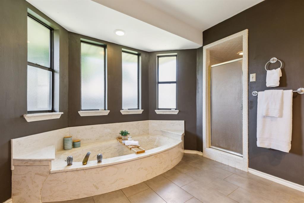 4130 High Star Lane Dallas, TX 75287 - Photo 26 of 38 a bathroom with a bathtub and a window