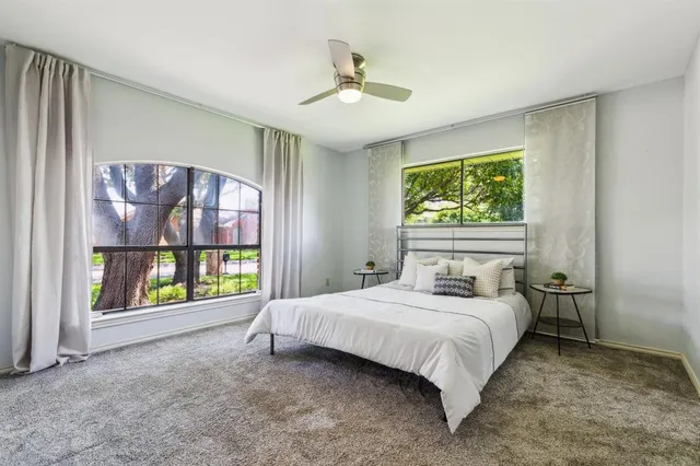 a bedroom with a bed flowerpot and window
