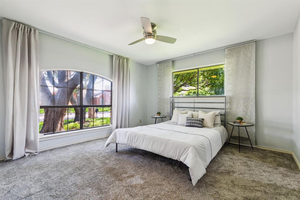 4130 High Star Lane Dallas, TX 75287 - Photo 27 of 38 a bedroom with a bed and a ceiling fan