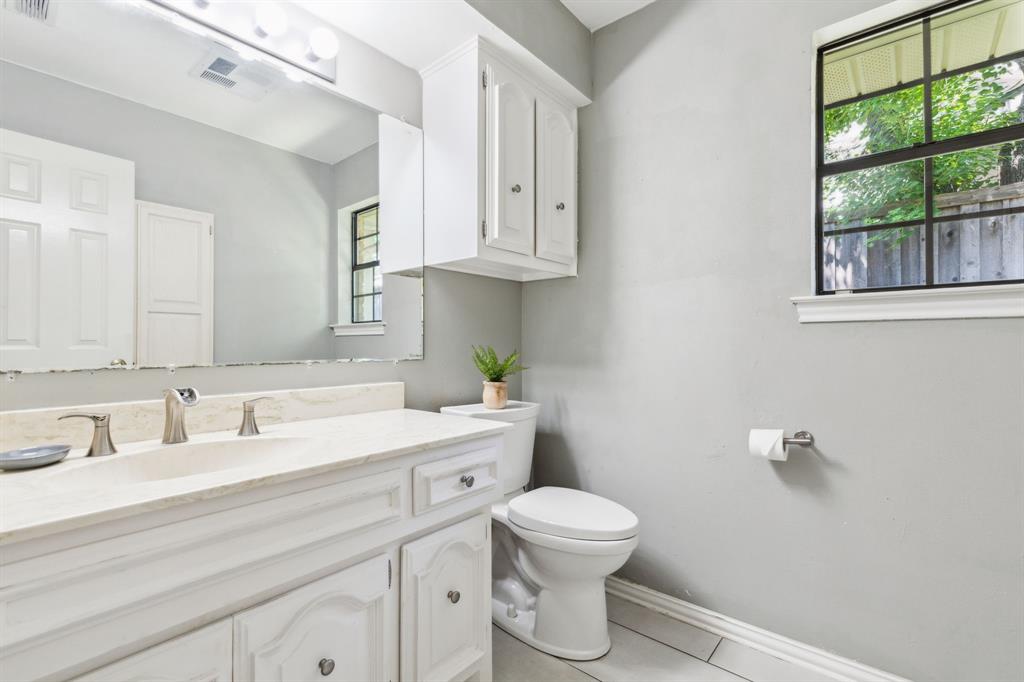 4130 High Star Lane Dallas, TX 75287 - Photo 30 of 38 a bathroom with a toilet sink and mirror