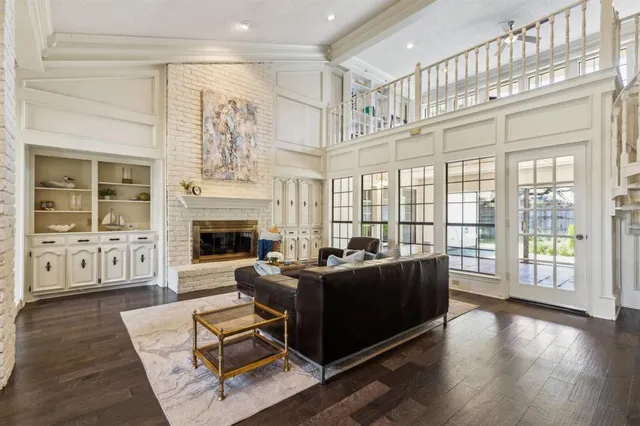 a living room with fireplace furniture and a wooden floor