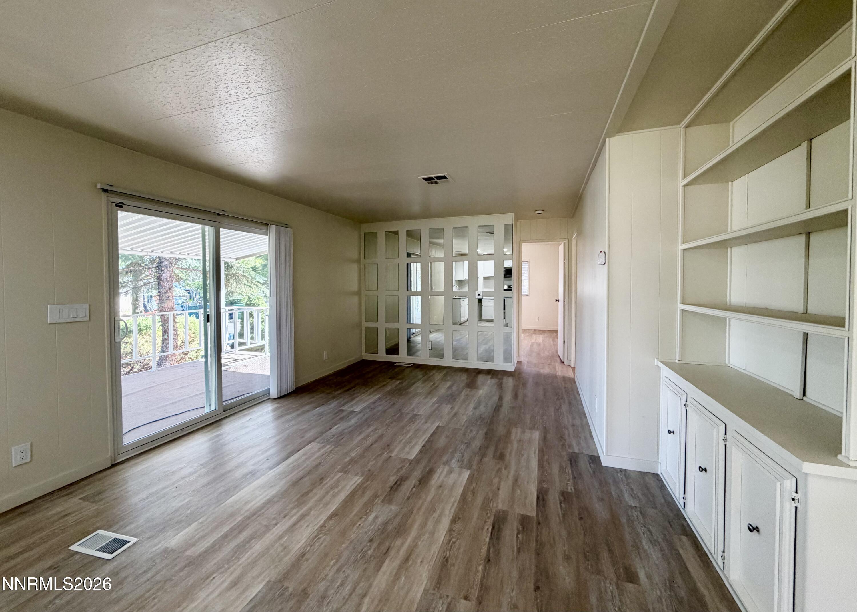 330 Taurus Circle Reno, NV 89521 - Photo 12 of 27 a view of an empty room with wooden floor and a window