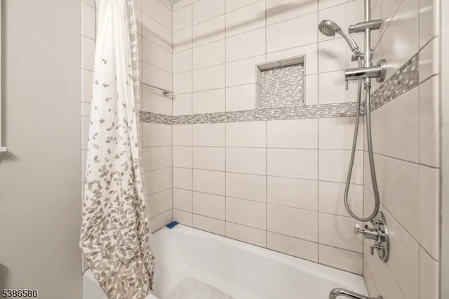 a bathroom with a bathtub and shower