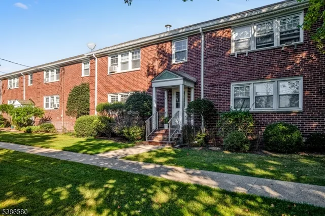 a view of a house with a yard and plants