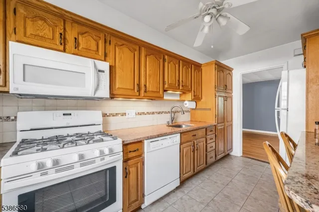 a kitchen with stainless steel appliances granite countertop a stove and a refrigerator