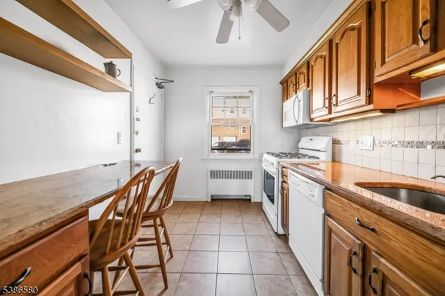 a kitchen with stainless steel appliances granite countertop a sink and cabinets