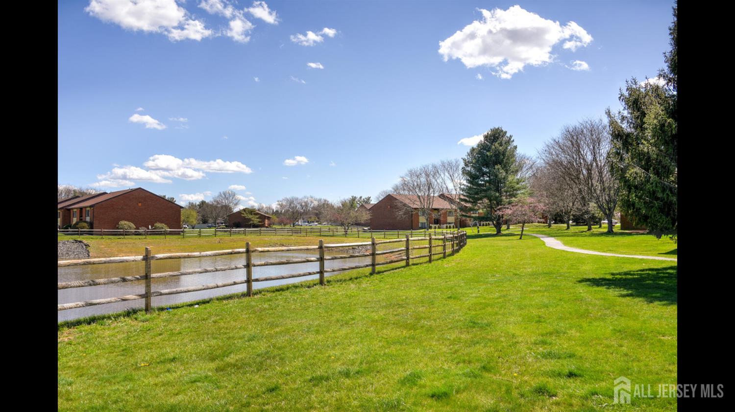 356 Ridge Road, Unit J12 Dayton, NJ 08810 - Photo 18 of 21 a view of a swimming pool with an outdoor seating a yard and a garden