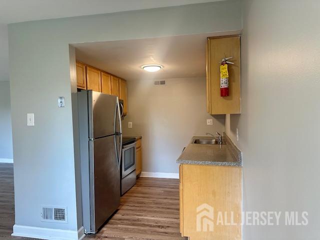 356 Ridge Road, Unit J12 Dayton, NJ 08810 - Photo 25 of 42 a kitchen with a refrigerator and cabinets