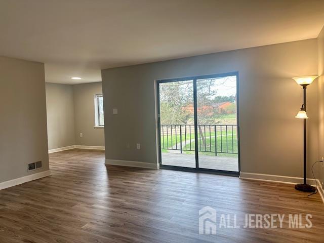 356 Ridge Road, Unit J12 Dayton, NJ 08810 - Photo 28 of 42 a view of an empty room with wooden floor and a window