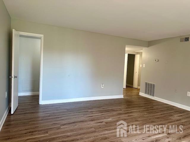 356 Ridge Road, Unit J12 Dayton, NJ 08810 - Photo 32 of 42 a view of an empty room with wooden floor