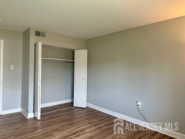 356 Ridge Road, Unit J12 Dayton, NJ 08810 - Photo 35 of 42 a view of an empty room with wooden floor