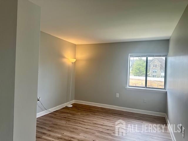 356 Ridge Road, Unit J12 Dayton, NJ 08810 - Photo 36 of 42 an empty room with wooden floor and windows