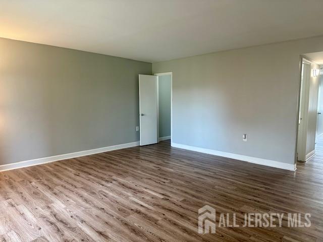 356 Ridge Road, Unit J12 Dayton, NJ 08810 - Photo 37 of 42 a view of an empty room with wooden floor