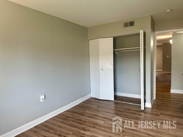 356 Ridge Road, Unit J12 Dayton, NJ 08810 - Photo 39 of 42 a view of empty room with wooden floor