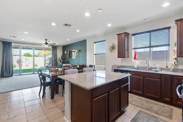 a kitchen with granite countertop a sink a stove and cabinets