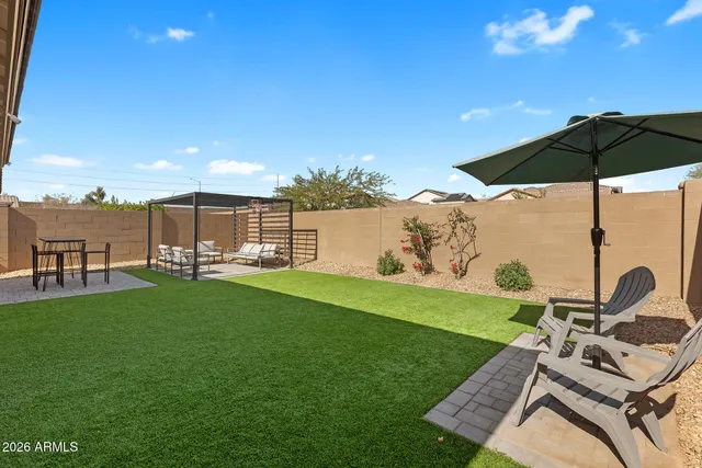 a patio with yard table and chairs