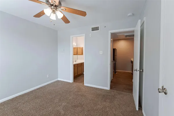 a view of a livingroom with a chandelier fan