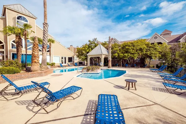 a view of a house with swimming pool and sitting area