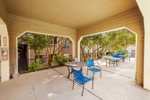 a building outdoor space with patio furniture and potted plants