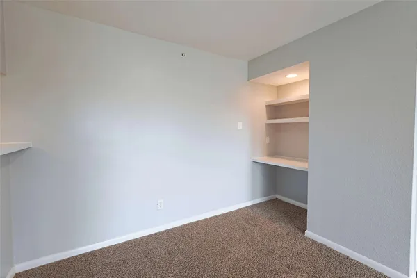 a view of an empty room and a window
