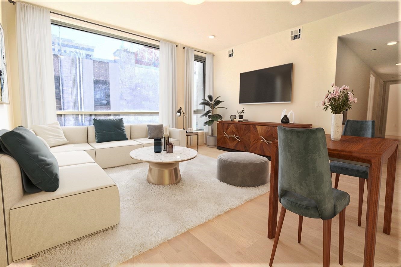 110 Court Street, Unit 2 Hoboken, NJ 07030 - Photo 2 of 14 a living room with furniture a flat screen tv and a large window
