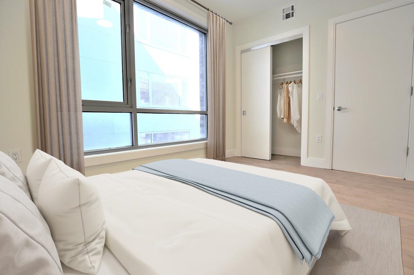 110 Court Street, Unit 2 Hoboken, NJ 07030 - Photo 6 of 14 a bedroom with a bed and a large window