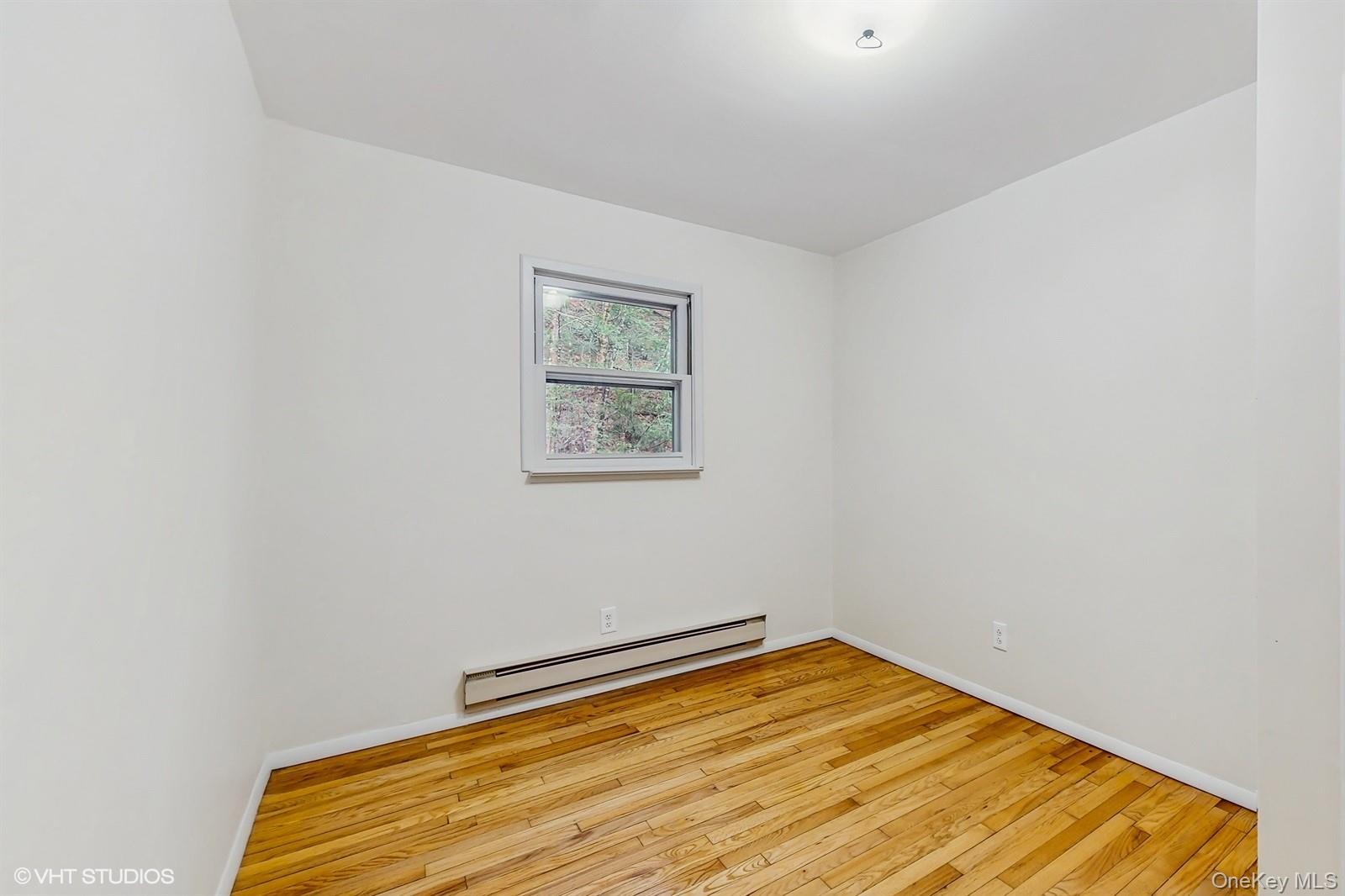 736 State Rte 55 Napanoch, NY 12458 - Photo 15 of 49 Room with light wood-style floors, baseboards, and a baseboard heating unit