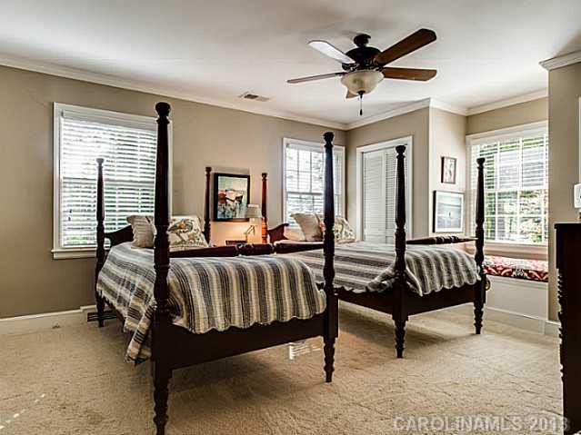 2035 Ferncliff Road Charlotte, NC 28211 - Photo 11 of 16 a spacious bedroom with a bed and a chandelier
