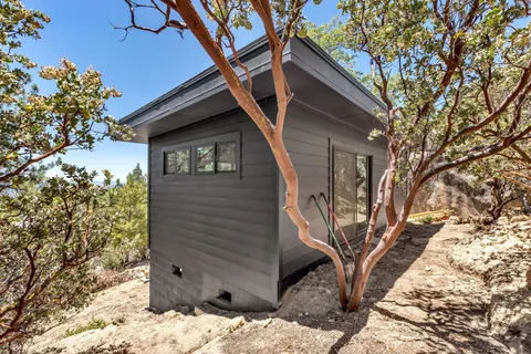 a view of a wooden house with a yard