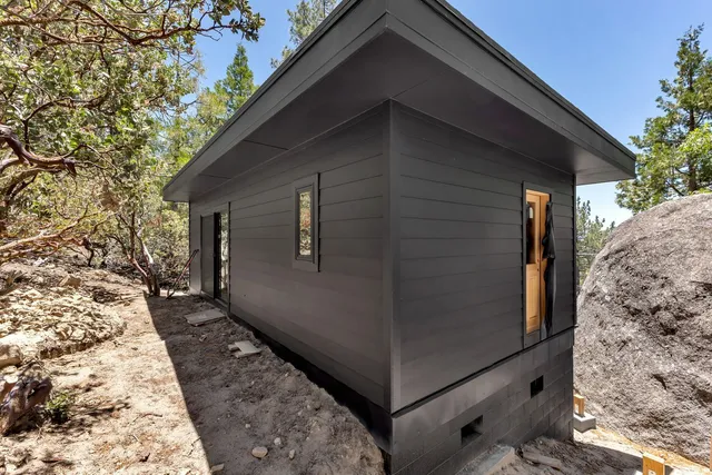a back view of a house with a wooden door