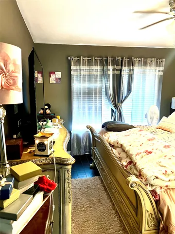 a bed sitting in a bedroom next to a window