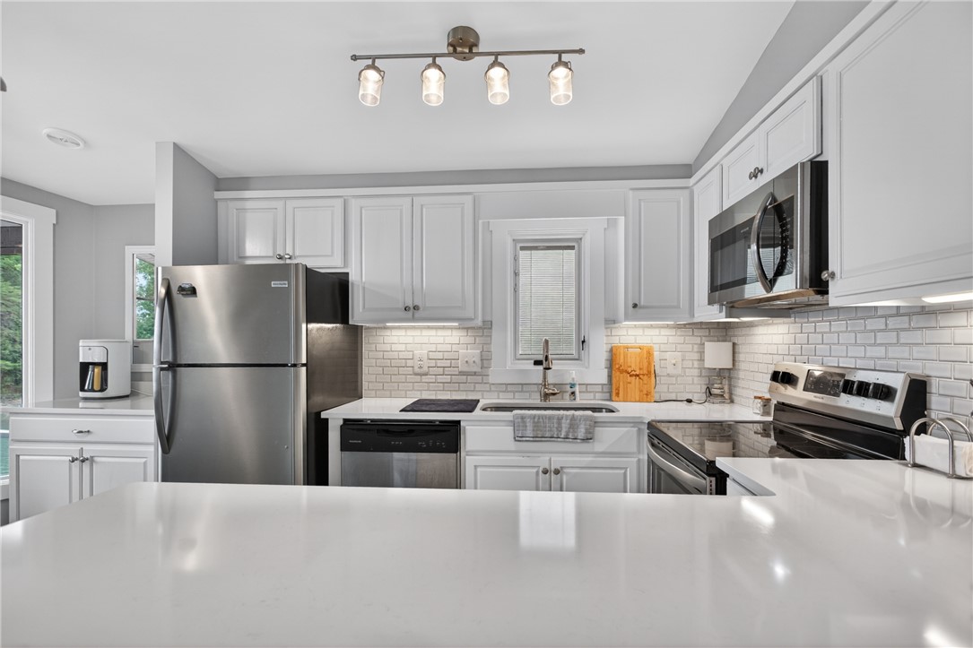1230 Melton Road, Unit 4 West Union, SC 29696 - Photo 38 of 48 A streamlined kitchen showcasing bright white cabinetry, subway tile backsplash, and sleek stainless steel appliances.
