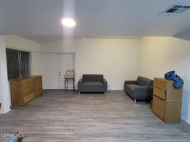 a view of a room with wooden floor