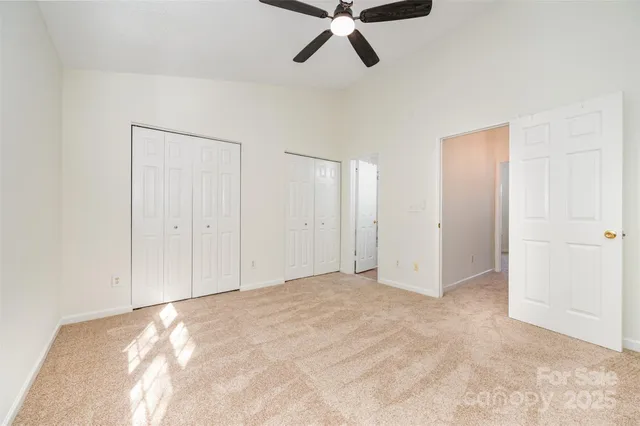 a view of a room with a ceiling fan