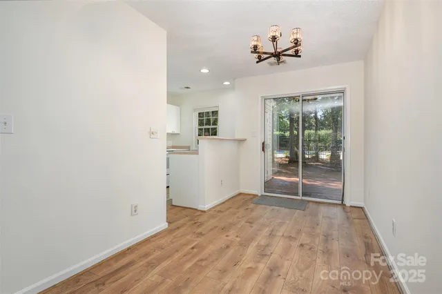 a view of a room with wooden floor and a window