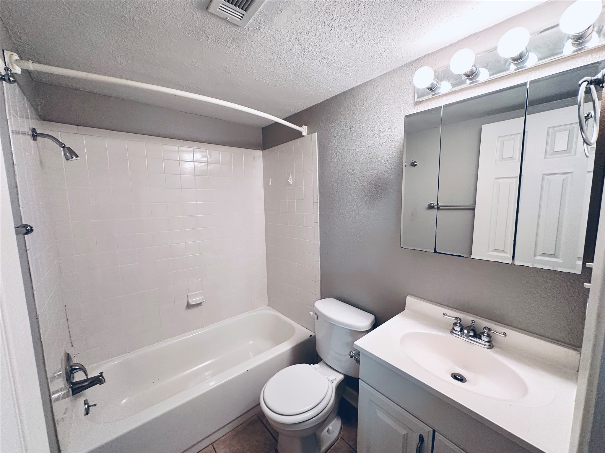2500 Burleson Road, Unit 209 Austin, TX 78741 - Photo 19 of 24 Functional full bathroom featuring a tub-shower combo and a vanity with ample counter space.