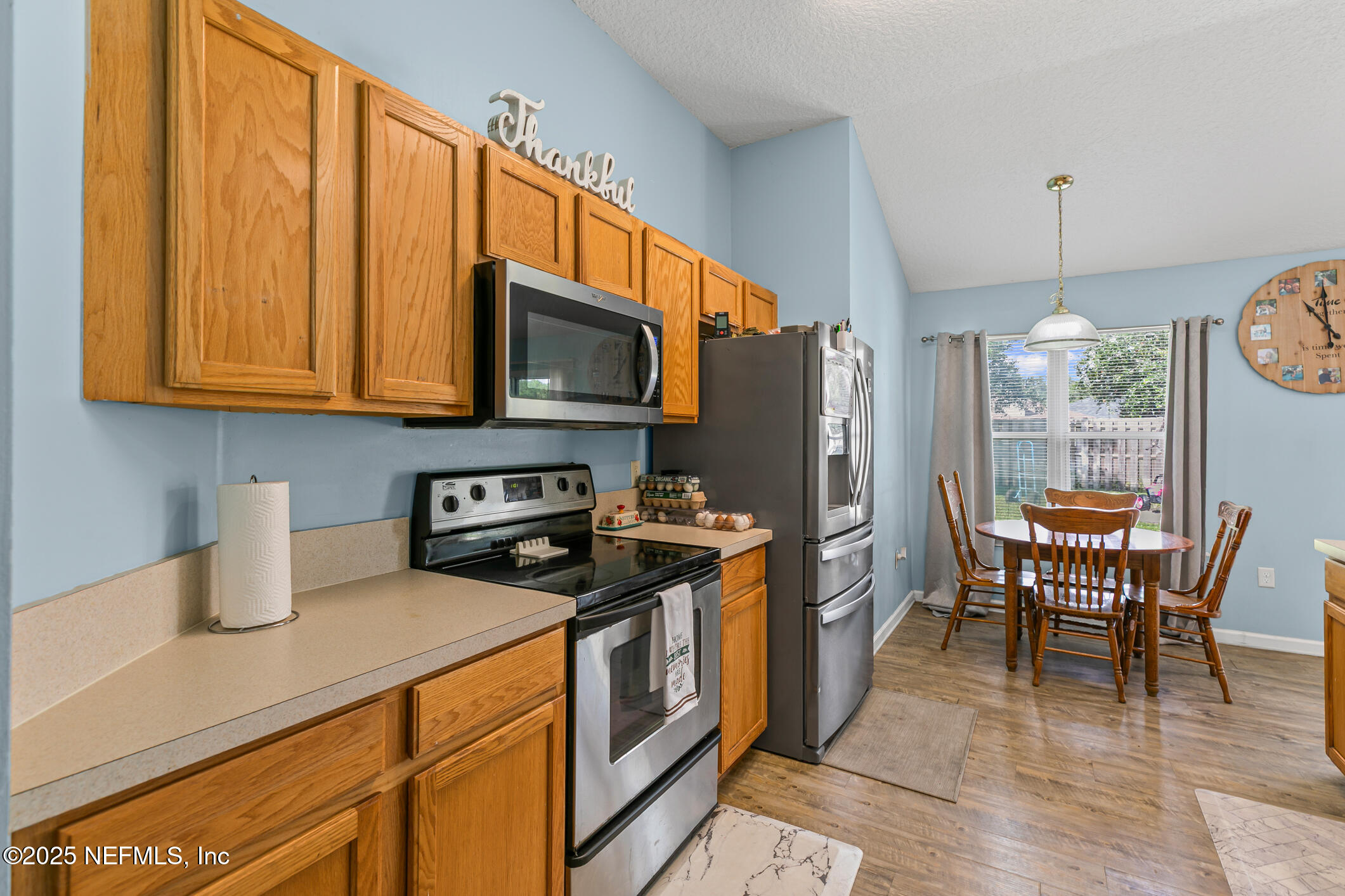 1725 South Summer Ridge Court St. Augustine, FL 32092 - Photo 15 of 46 a kitchen with stainless steel appliances granite countertop a stove a sink a microwave and a refrigerator
