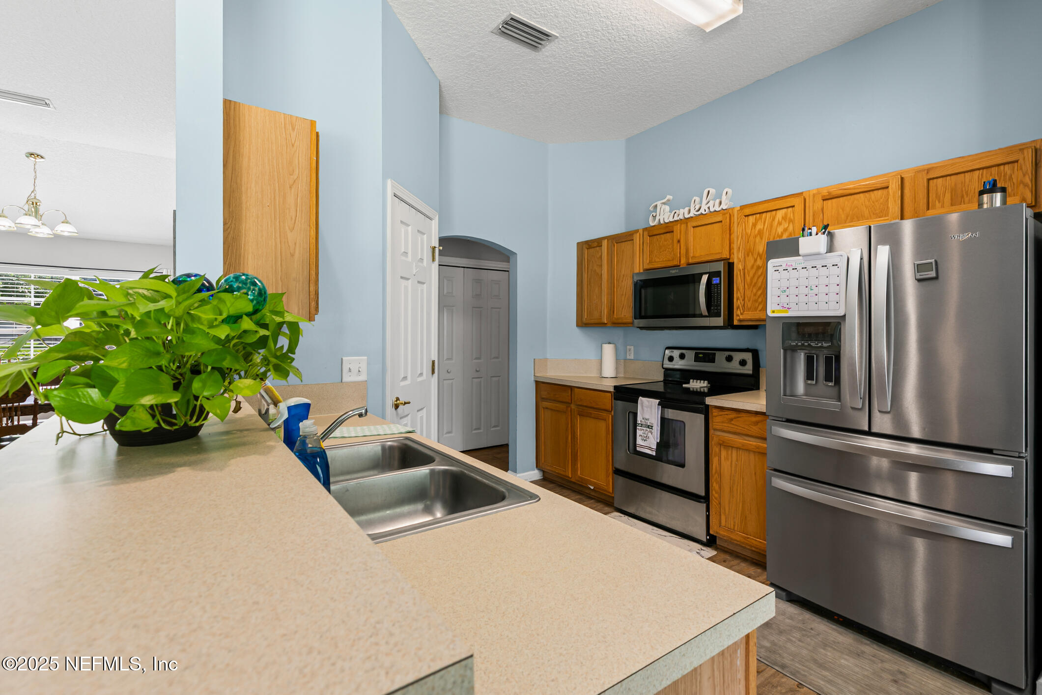 1725 South Summer Ridge Court St. Augustine, FL 32092 - Photo 18 of 46 a kitchen with stainless steel appliances a microwave a sink a stove and a refrigerator