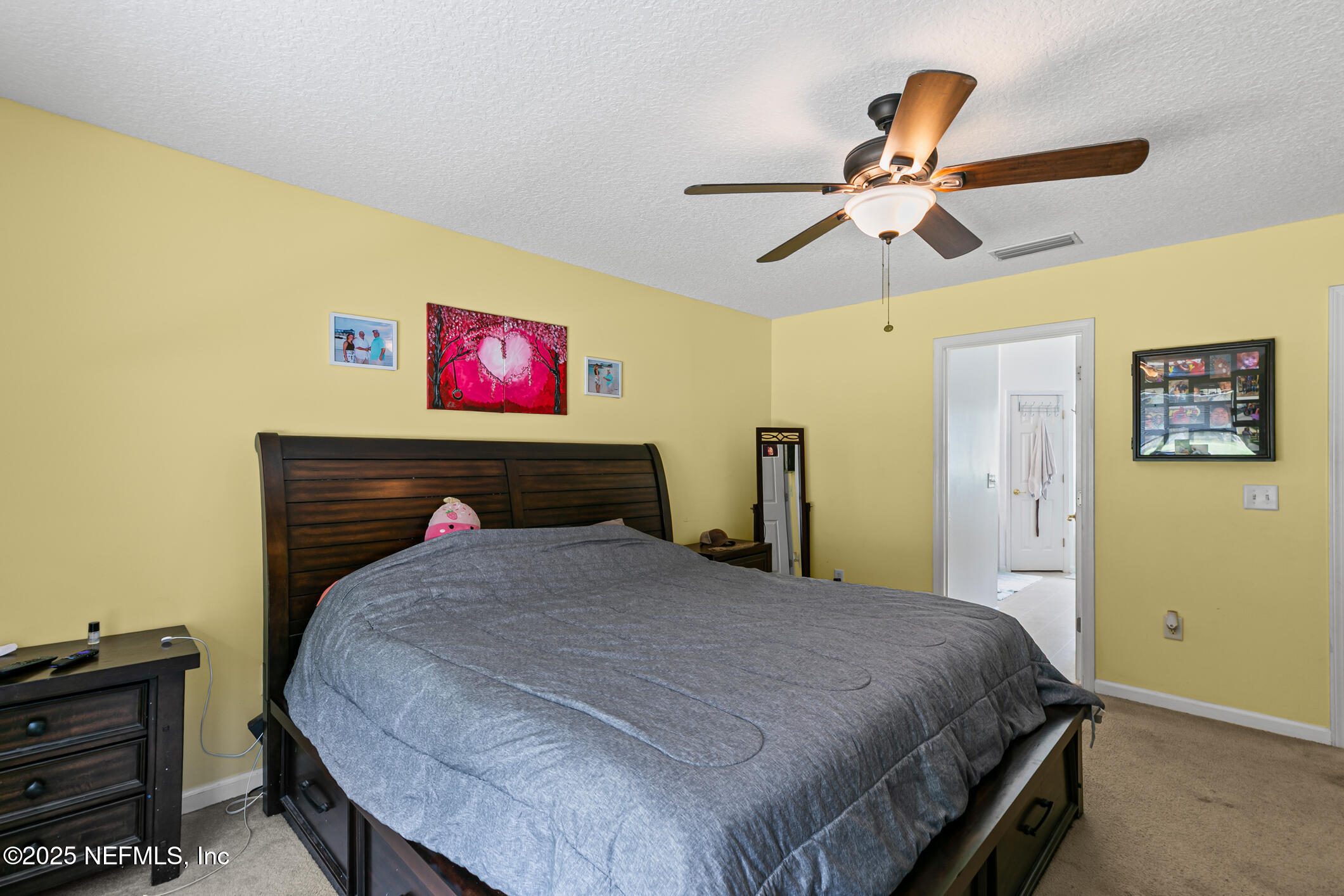 1725 South Summer Ridge Court St. Augustine, FL 32092 - Photo 31 of 46 a bedroom with a bed and a chandelier