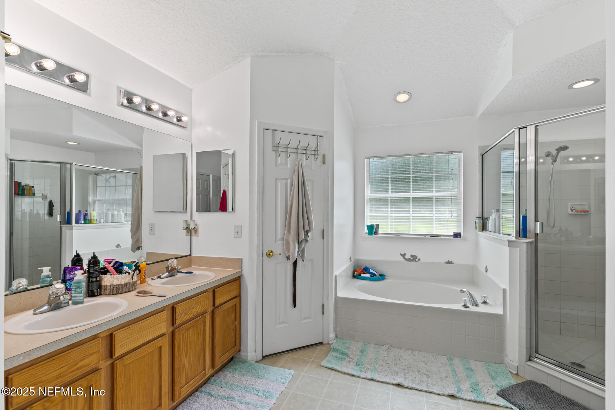 1725 South Summer Ridge Court St. Augustine, FL 32092 - Photo 33 of 46 a spacious bathroom with a tub sink and mirror