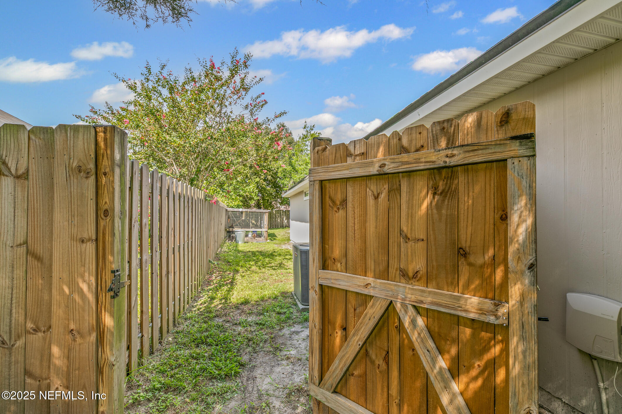1725 South Summer Ridge Court St. Augustine, FL 32092 - Photo 37 of 46 a view of a house with a door and wooden fence