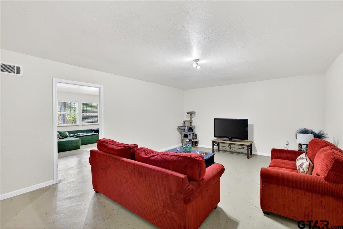 2375 County Road 3282 Buffalo, TX 75831 - Photo 17 of 48 a living room with furniture a flat screen tv and a window