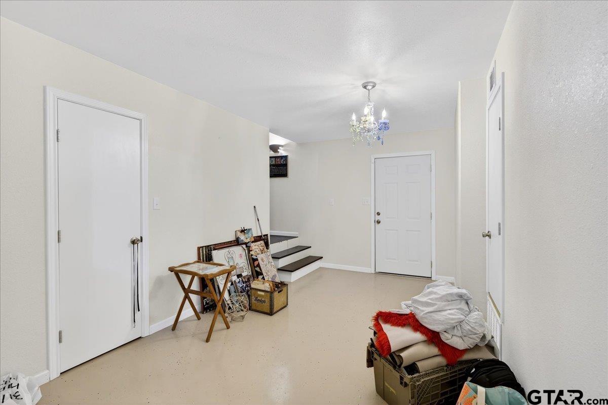 2375 County Road 3282 Buffalo, TX 75831 - Photo 29 of 48 a bedroom with furniture and a chandelier fan