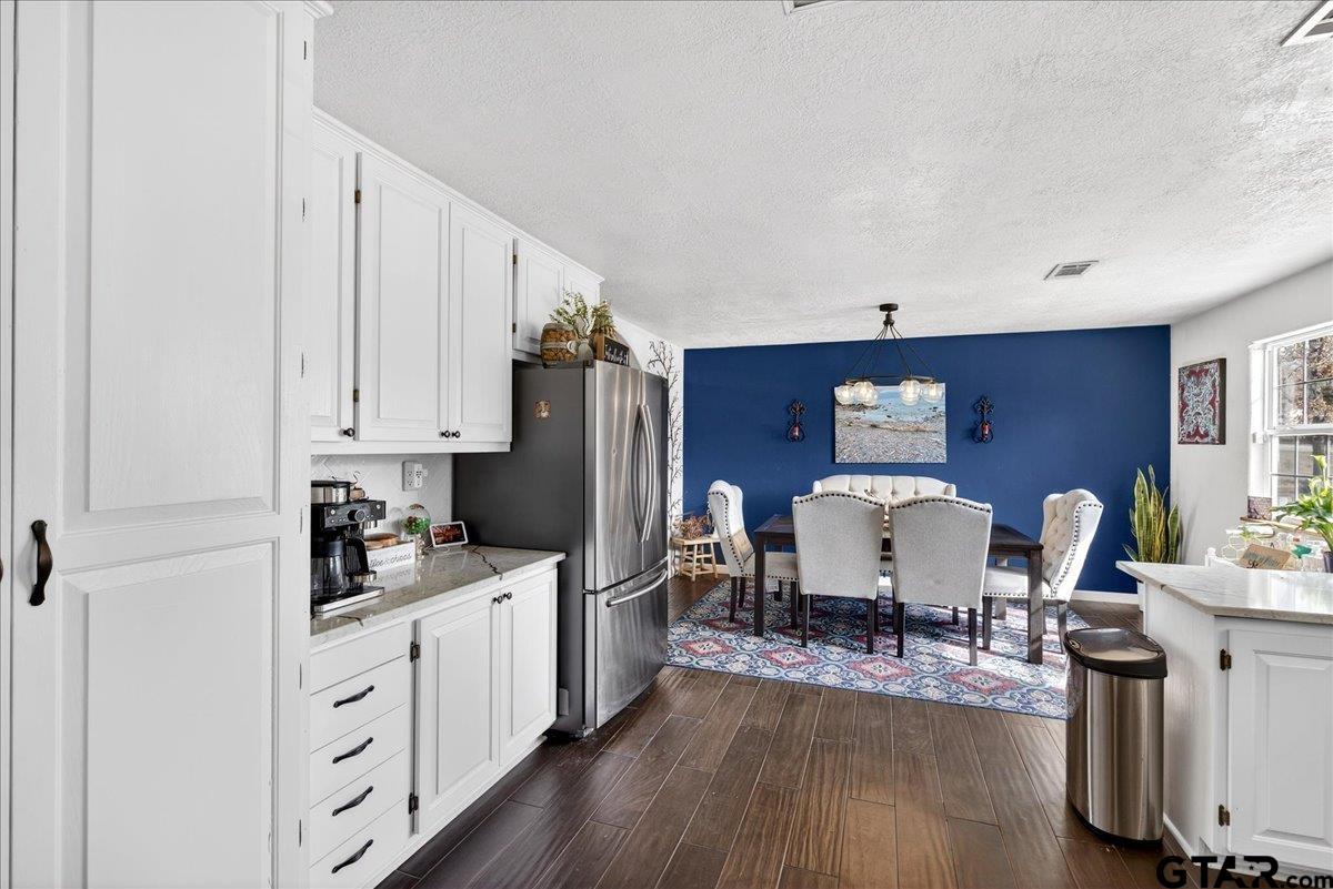 2375 County Road 3282 Buffalo, TX 75831 - Photo 4 of 48 a kitchen with stainless steel appliances a dining table chairs refrigerator and sink